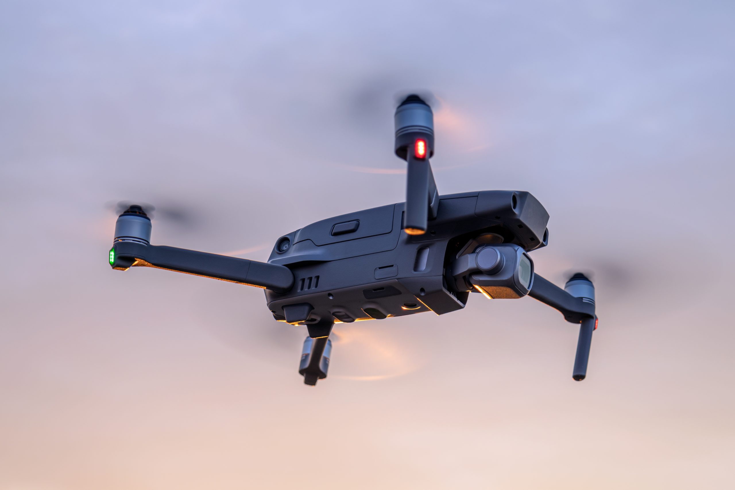 Quadcopter in flight against the sky, view from below. Close-up